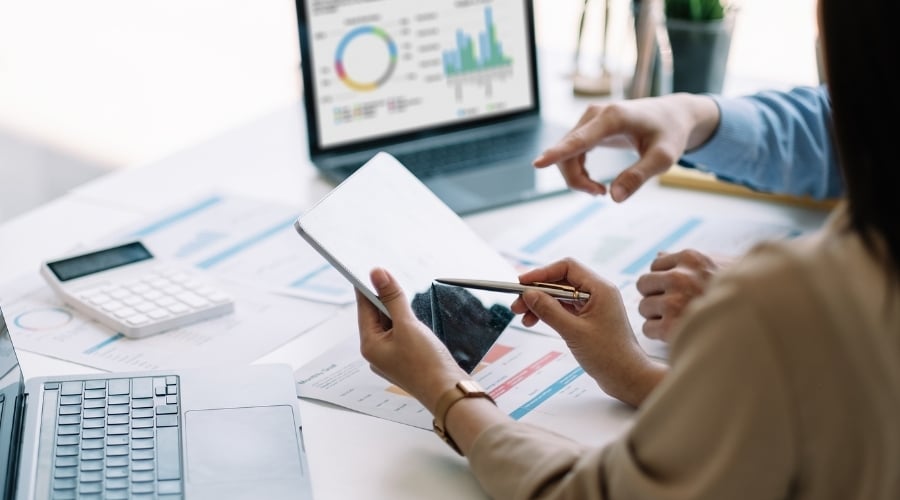 People tracking data on tablet and computer