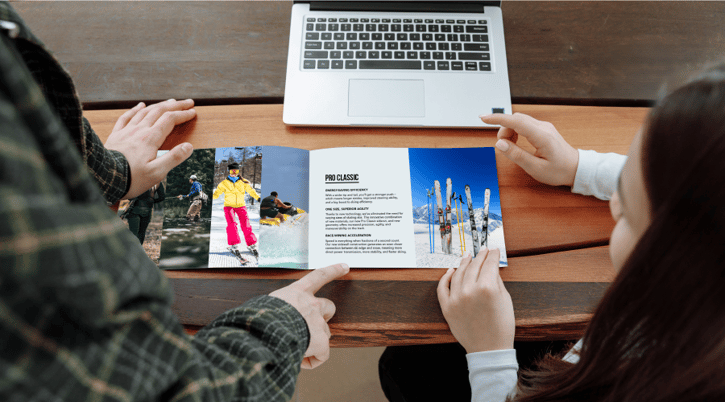 People flipping through a catalog style mail piece 